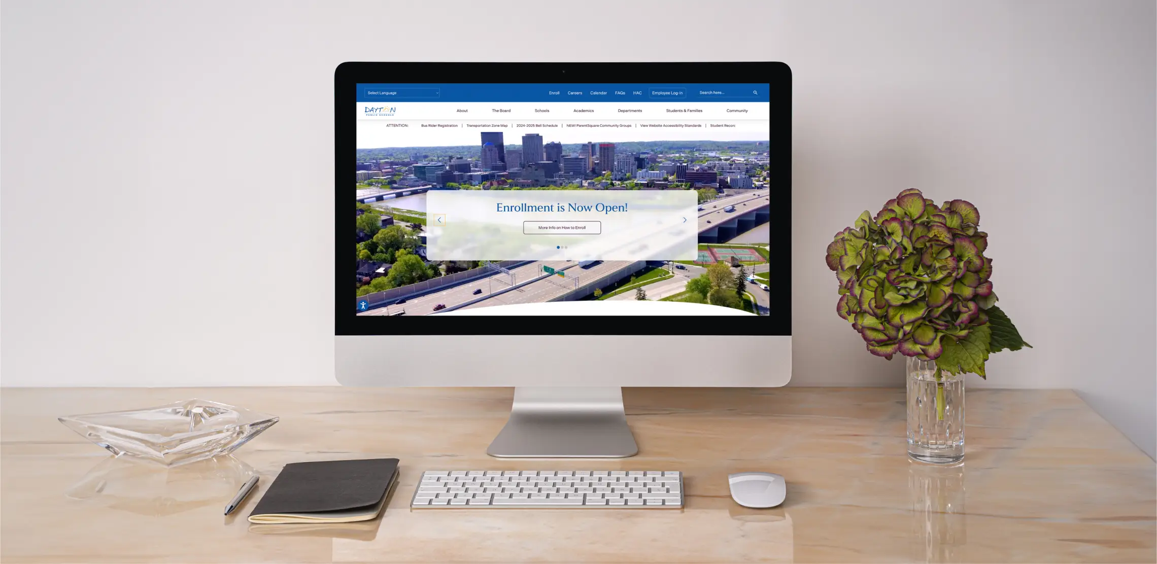 Dayton Public Schools desktop view of website with a keyboard and mouse
